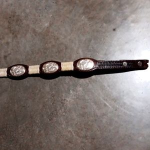 Women's size 28 belt made with leather and sliver decorative designs.